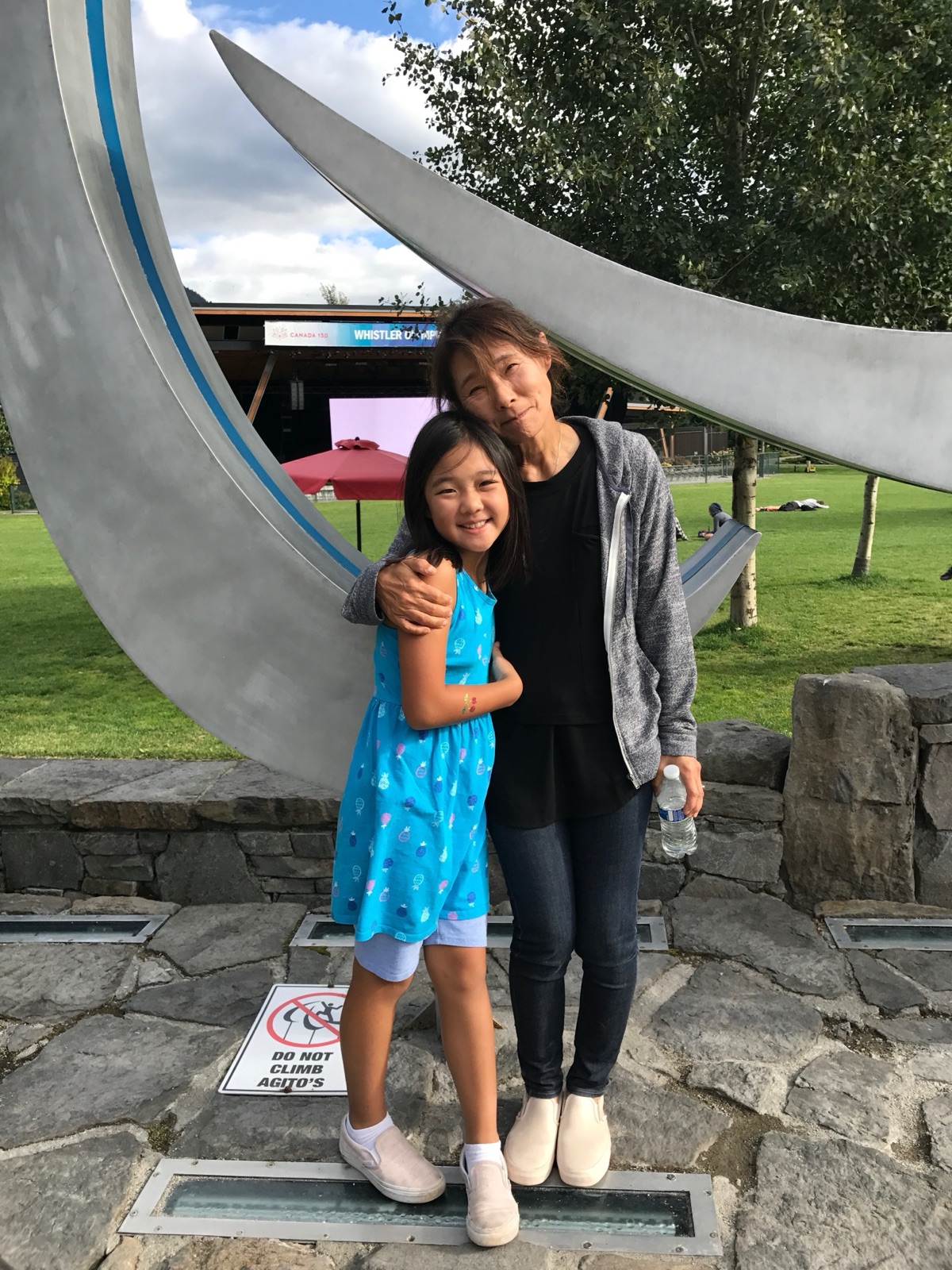 Marisa Woo standing with Grandma Woo outdoors